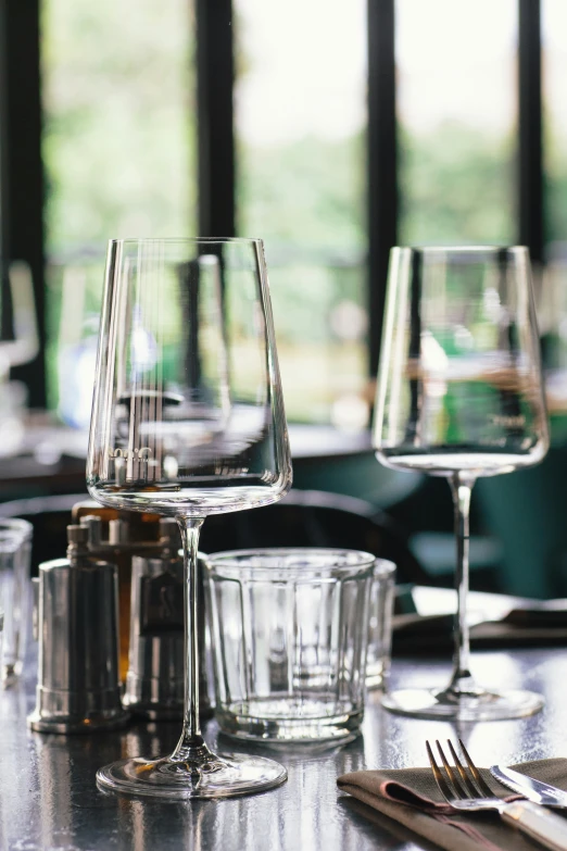 several clear goblets and wine glasses on a table