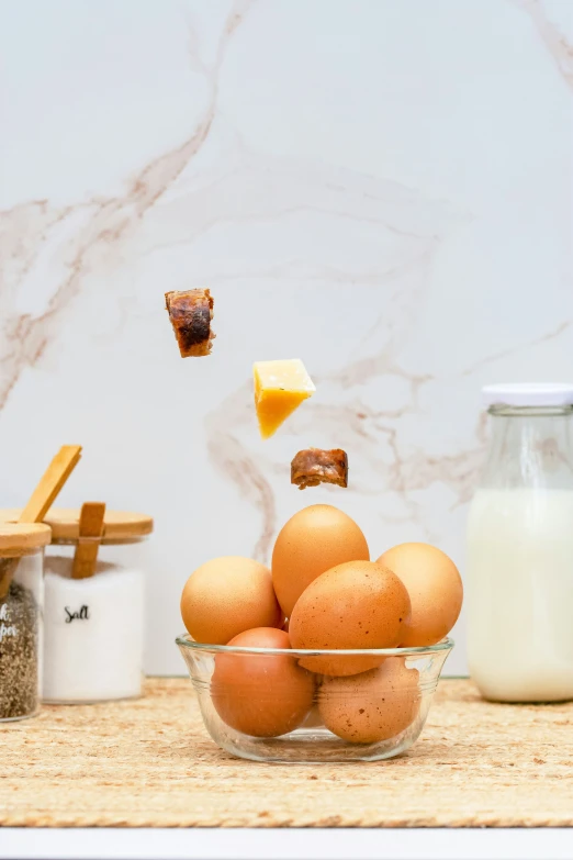 several eggs and milk sitting in glass dishes on a counter