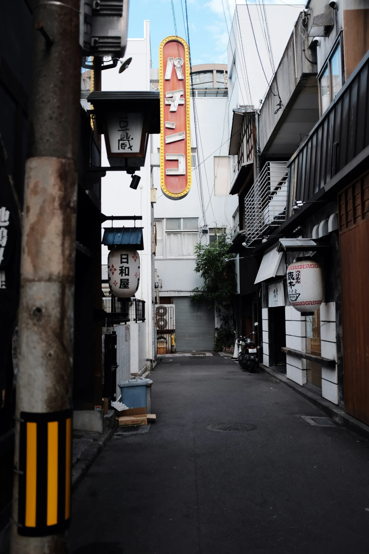 an alleyway with buildings and signs on it