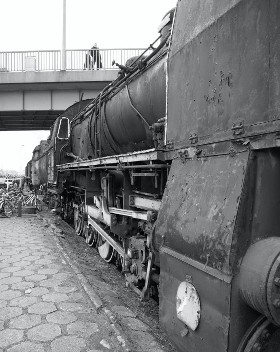 some very old train cars near a bridge