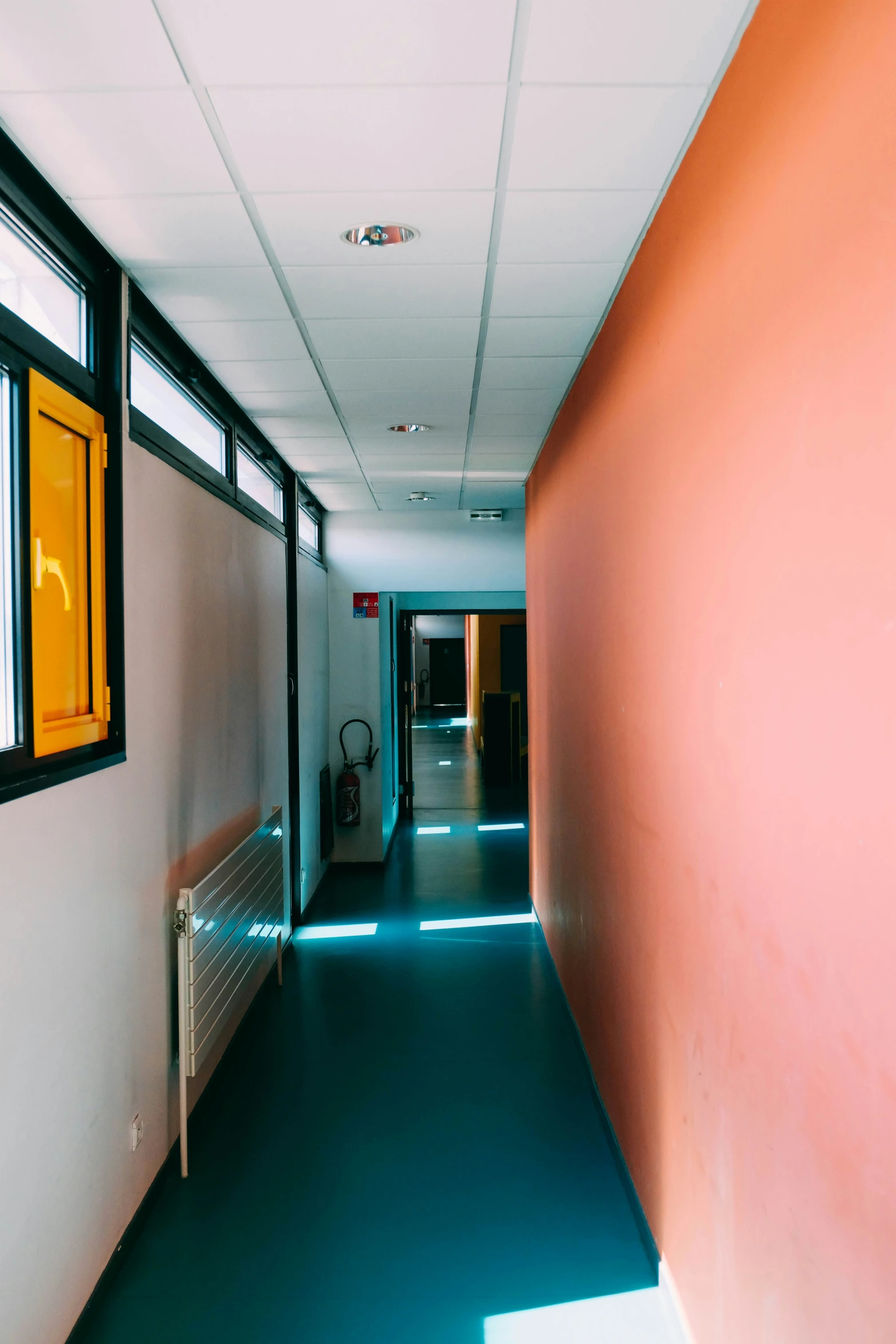 the corridor in the office building is brightly lit by the window and the sky