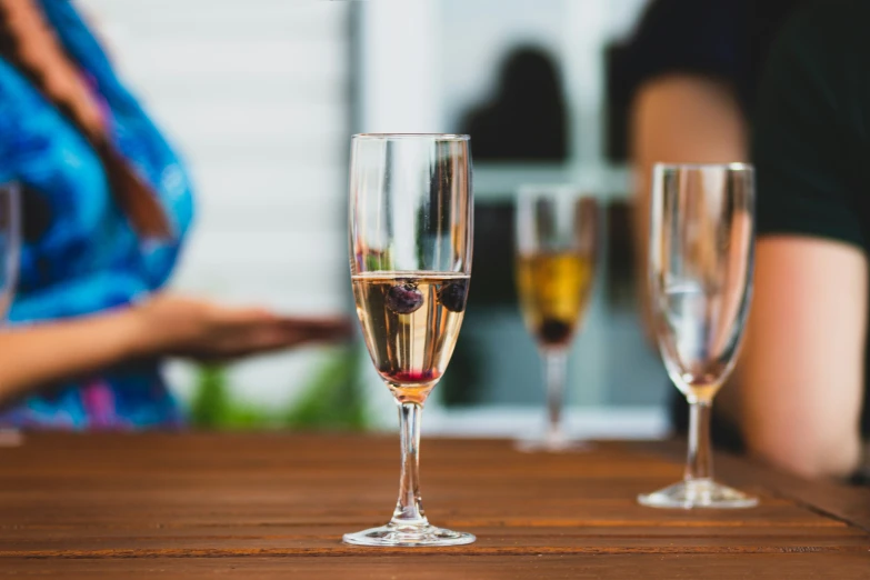 three glasses of wine sitting on a table