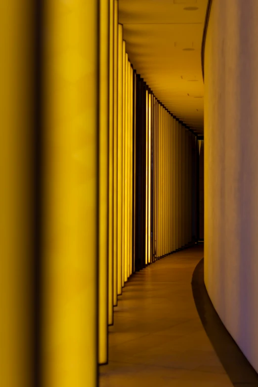a long corridor with yellow lines going into some buildings