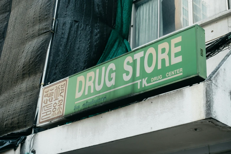 the sign for a drug store is above the building