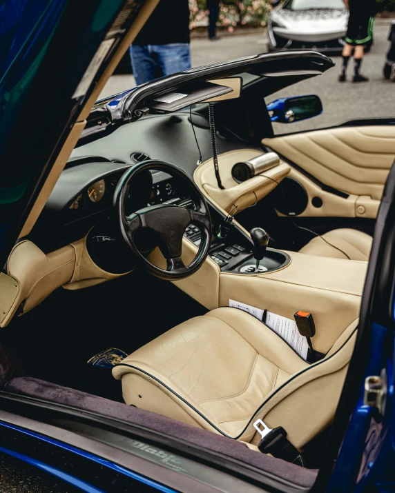 a car dashboard with a tan leather upholstered seat and dash