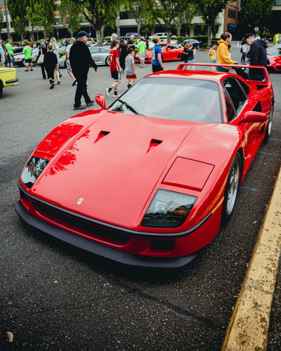 a red sport car parked at a show