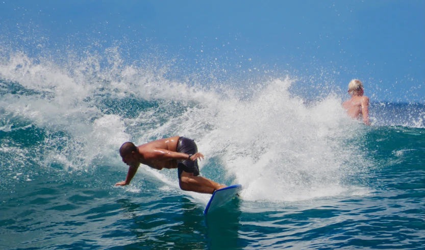 a person riding a surfboard on top of a wave