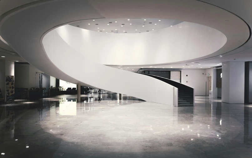 the large spiral staircase has been designed by a modern pographer