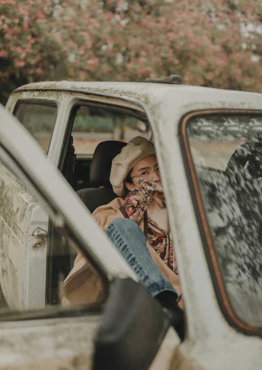 a woman in a cowboy hat sitting behind the driver seat