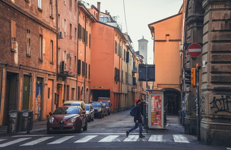 a person is walking down a cobblestone street