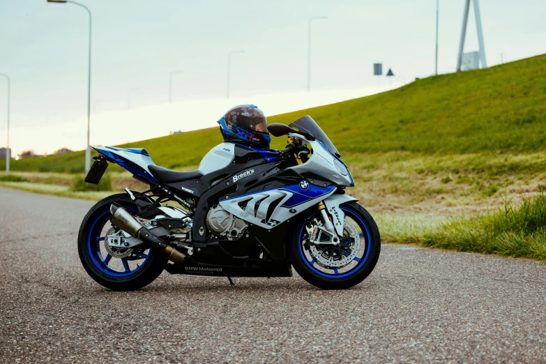 a motorcycle rider leans back on a winding road