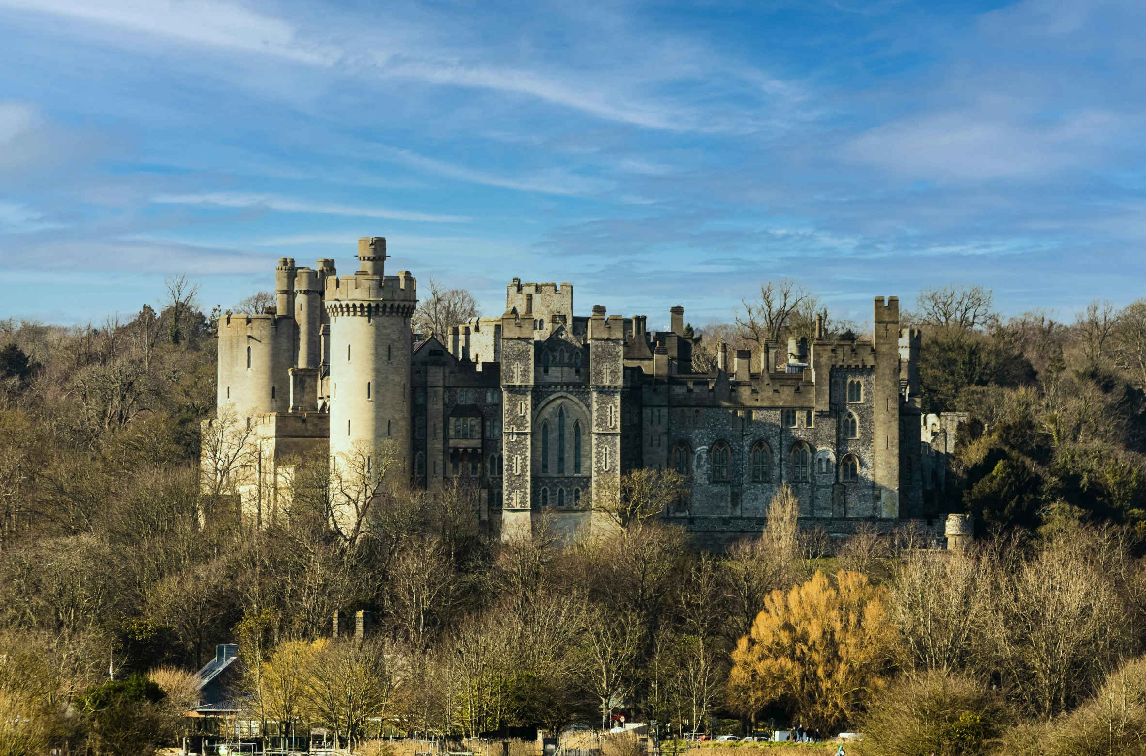 an old castle with trees surrounding it