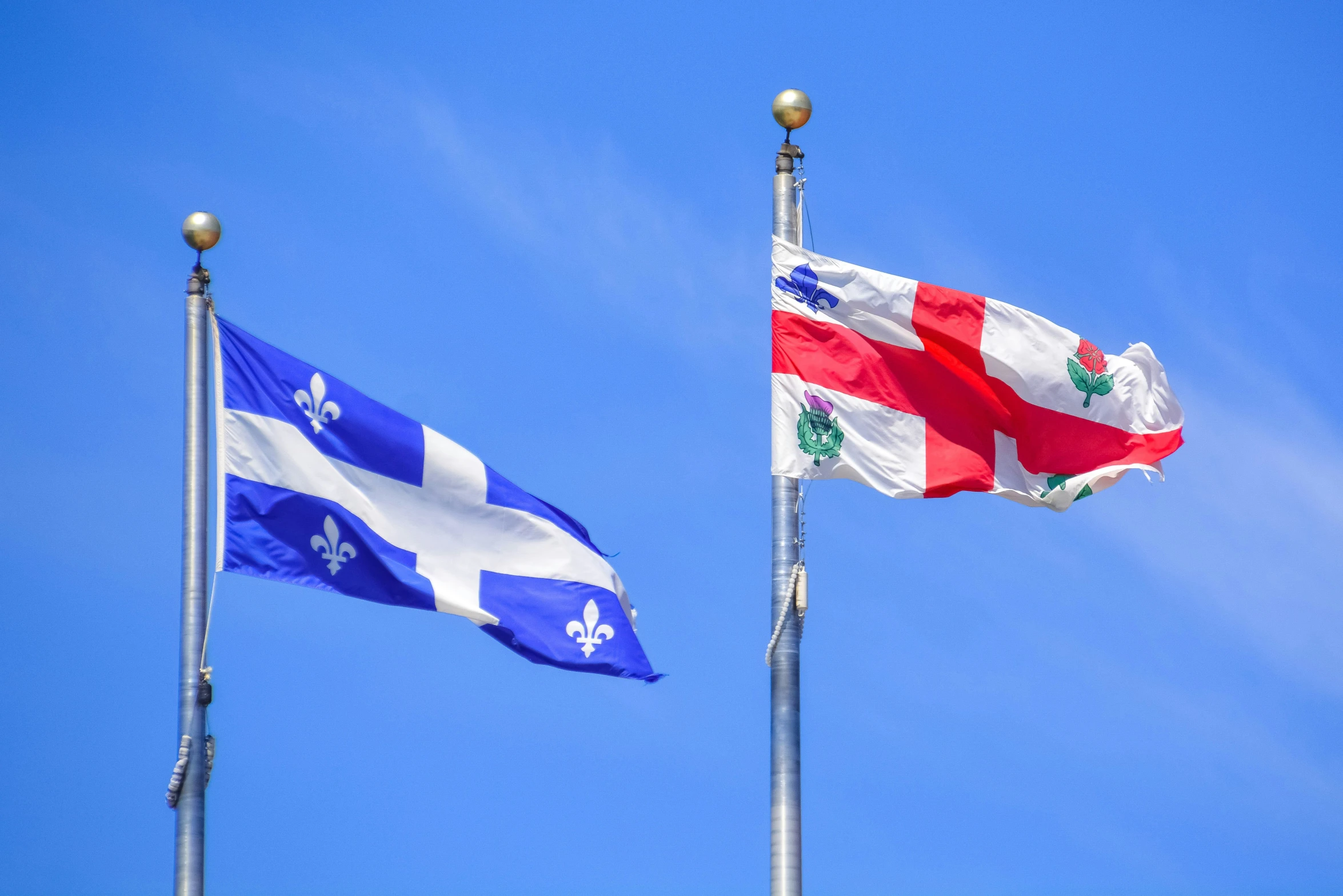 a couple of flags flying next to each other