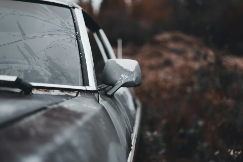 an abandoned car has broken into pieces