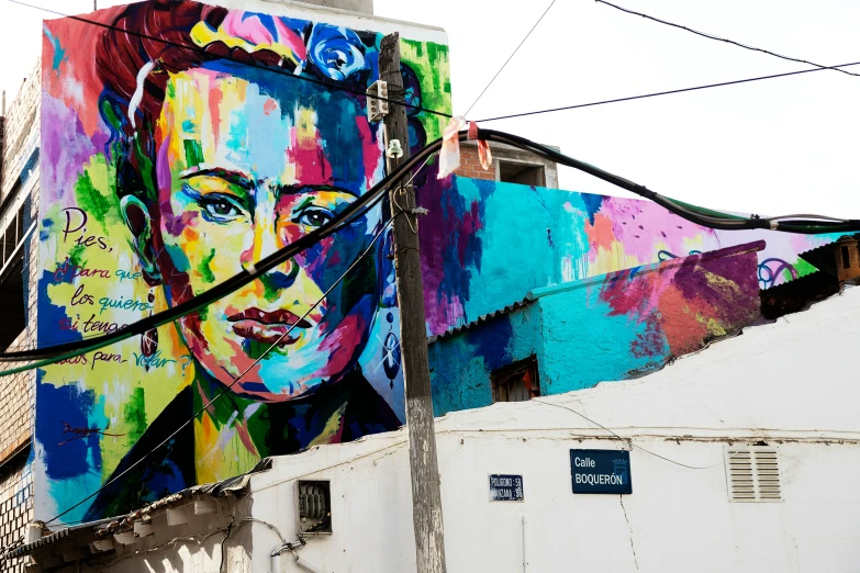 a big colorful portrait on the side of a building