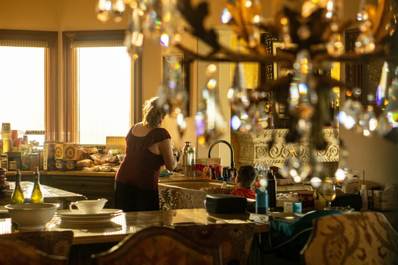 a woman in a large kitchen next to a counter