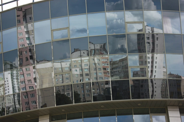 the reflection of city buildings in a glass wall