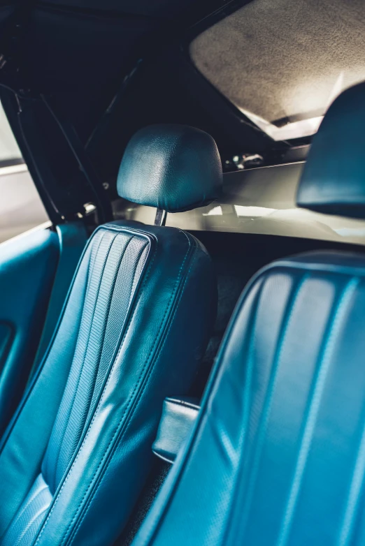 a blue seat sitting in a vehicle next to a back door