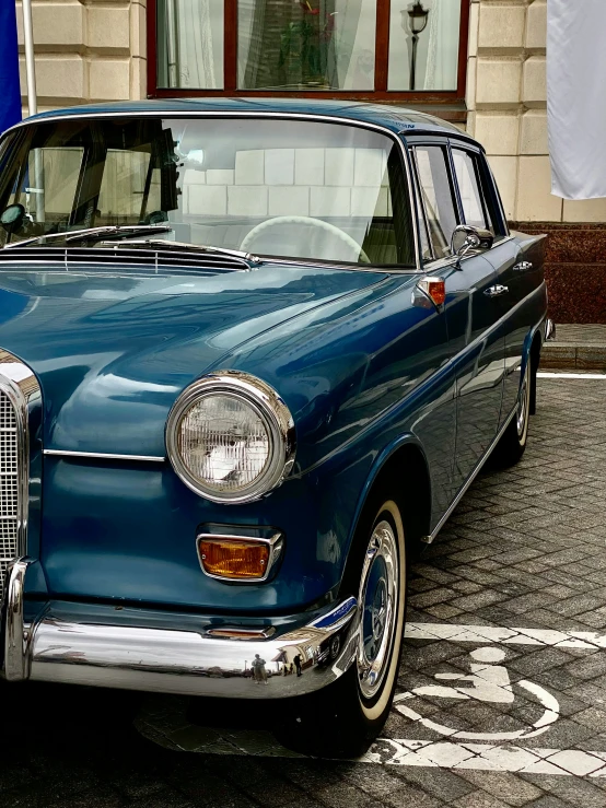 an old car that is parked in the street