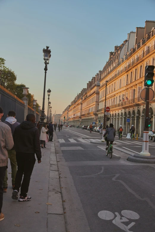 people on bikes and people riding bikes on a city street