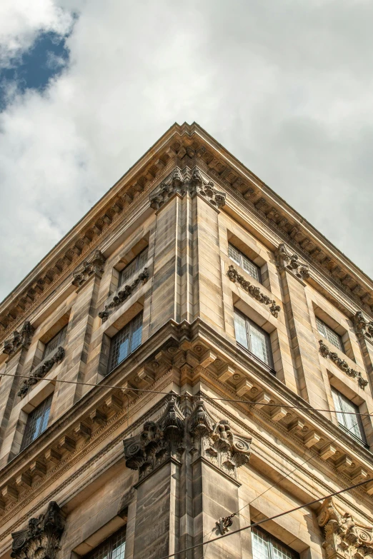 an upward view of a very tall building with lots of windows