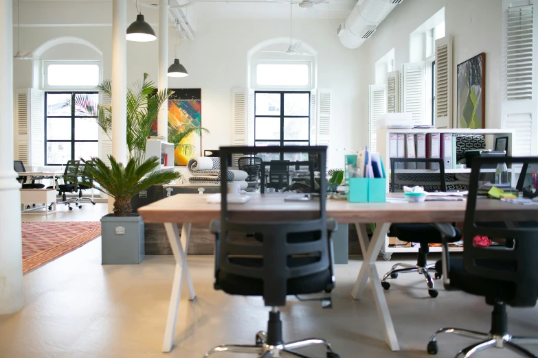 a room filled with different office chairs and tables