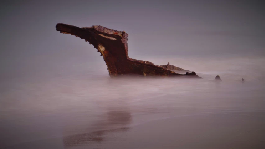 a ship wreck sitting on top of a sandy beach