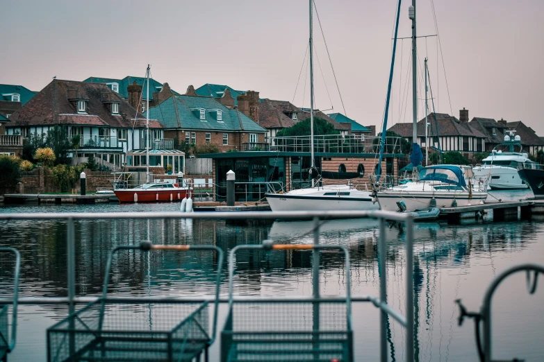 several yachts docked next to some houses