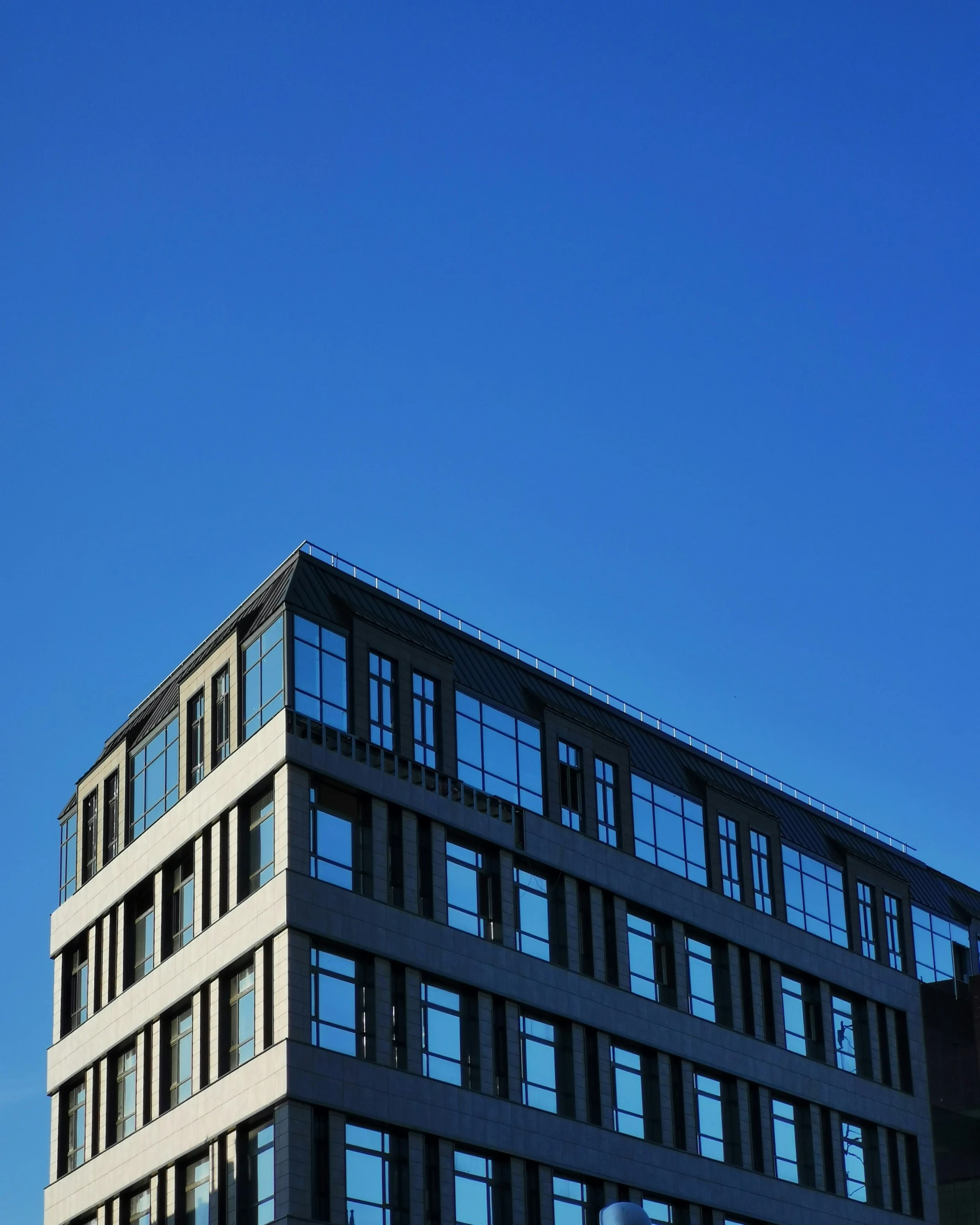 the outside of a very tall building with lots of windows