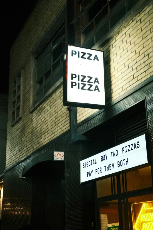 two street signs are posted in front of a building