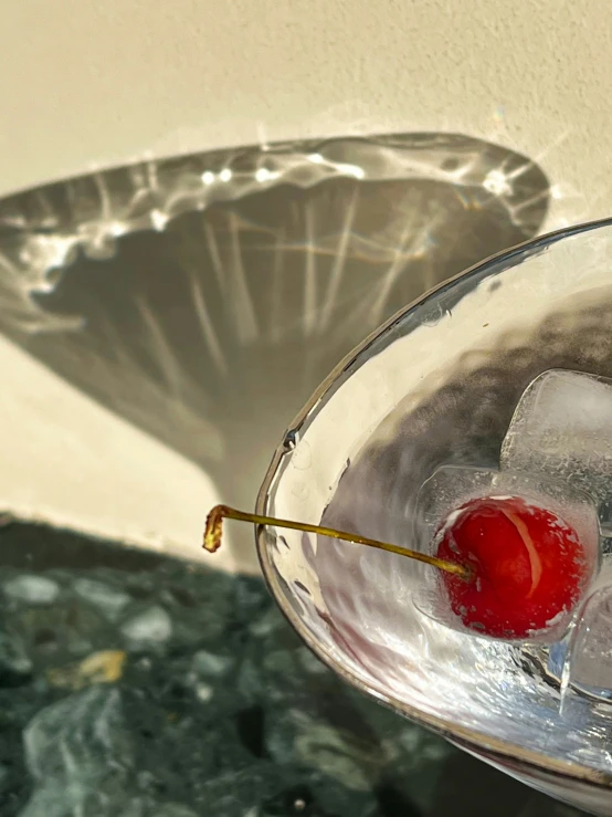 there is a martini glass filled with a cherries on top