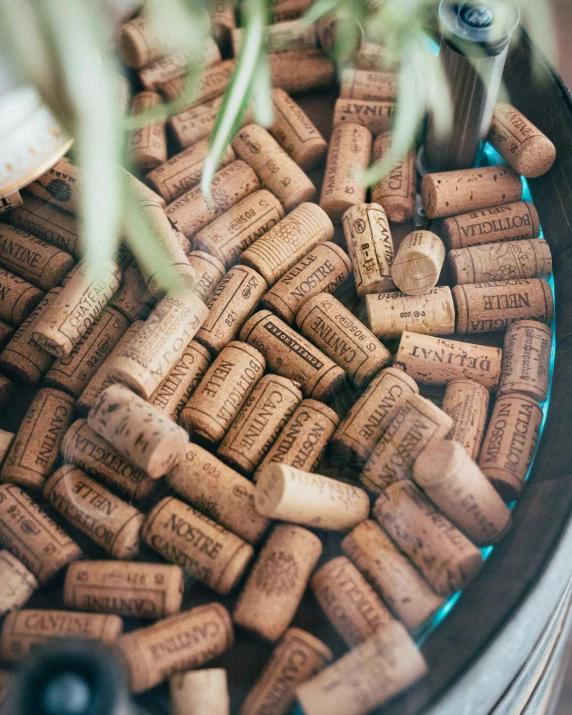 a glass container with several wine corks inside of it