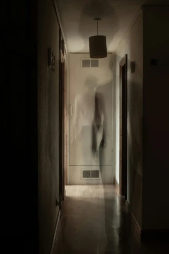 a ghost figure is walking down a hall way