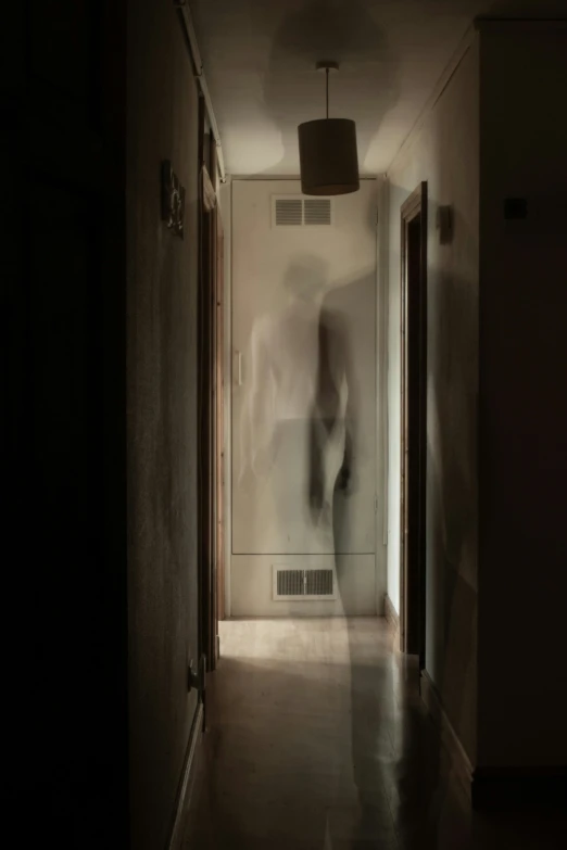 a ghost figure is walking down a hall way