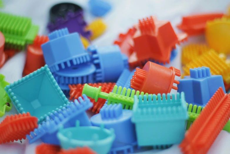 a pile of toy colorful plastic buildings sitting on top of a white table