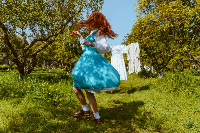 a woman in a costume walking in an open field