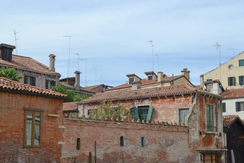 a row of buildings that have some green plants growing out of them