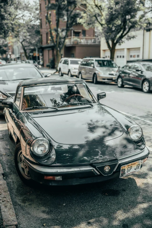 a black car sitting on the side of the street