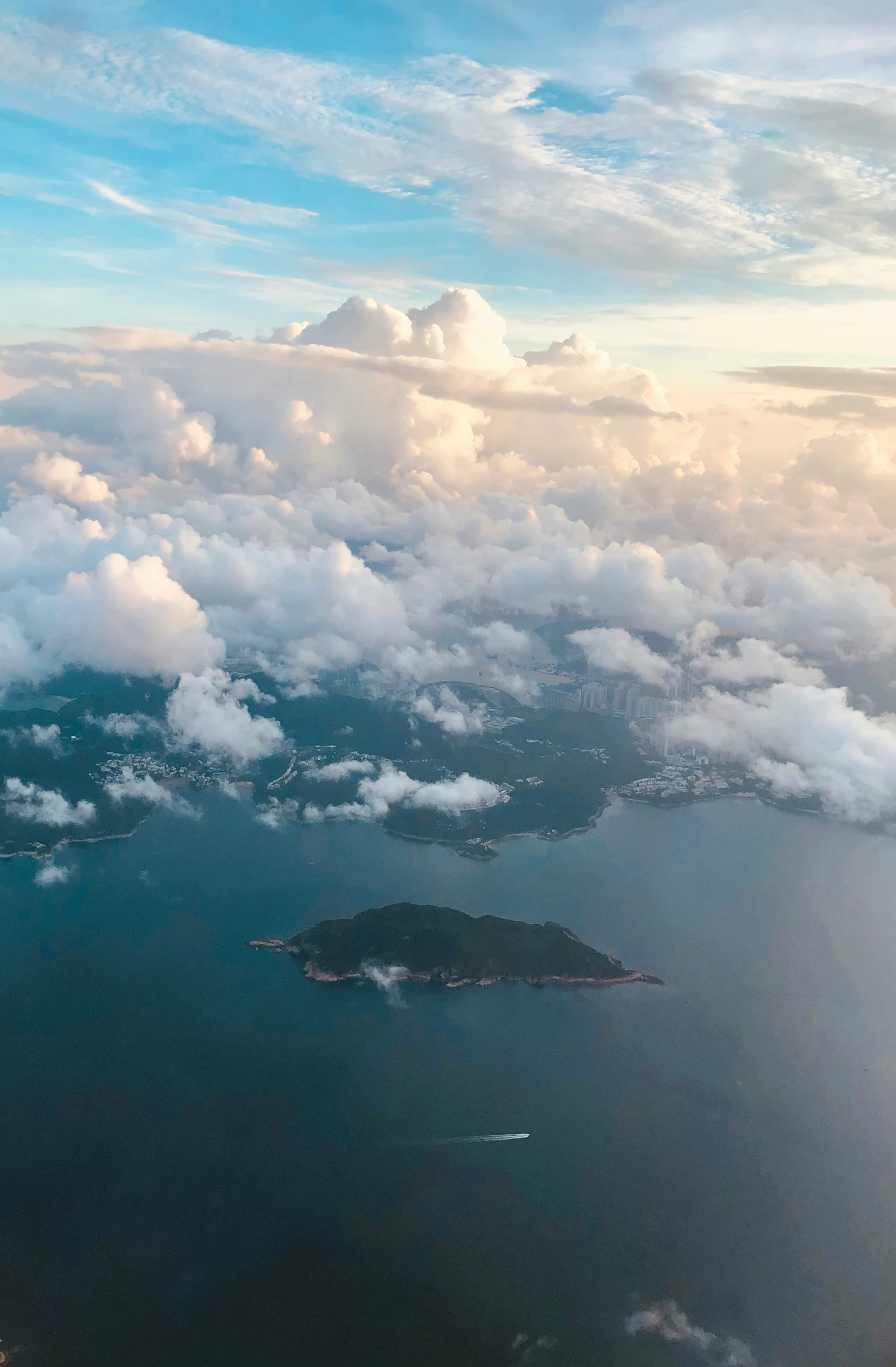 the view from a plane looking down on clouds and land