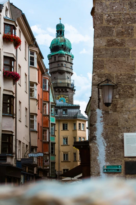 a tower on top of some buildings in a town