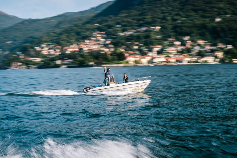 two men and a boat on a large body of water