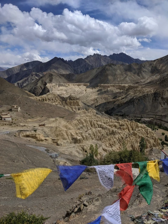 a mountain range covered with many colored flags