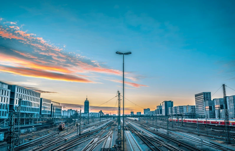 many train tracks and a sky filled with colorful clouds