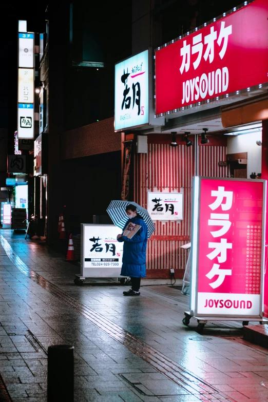 a man sitting on a bench in a dark city