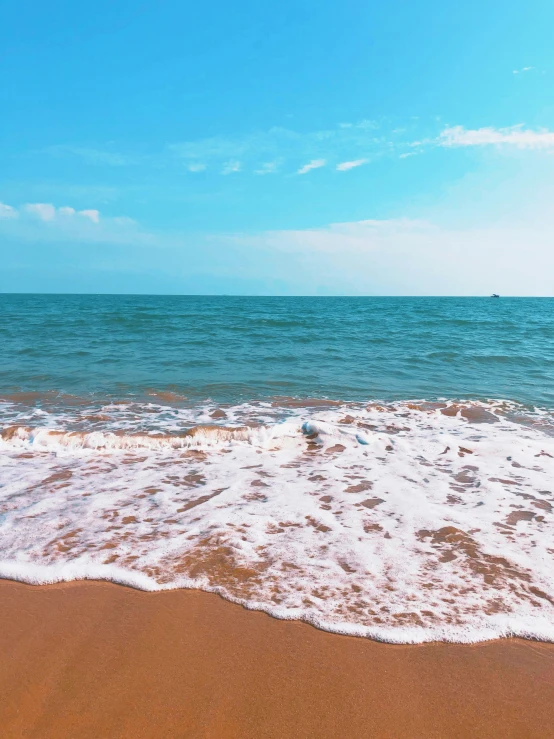 a beach that is wet and has a surfboard on the beach