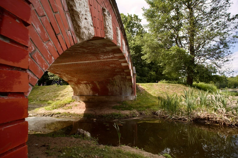 a red bridge with some water underneath