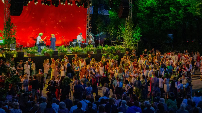 a crowd of people standing on top of a stage