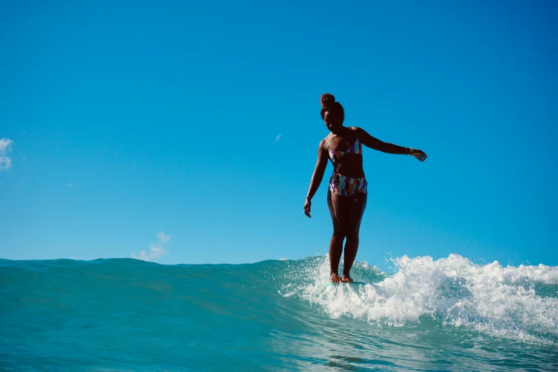 there is a female surfer in the water riding a wave