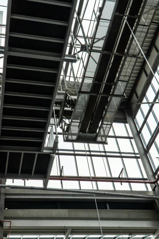 a view from the ground of two ceiling windows and a suspended fixture
