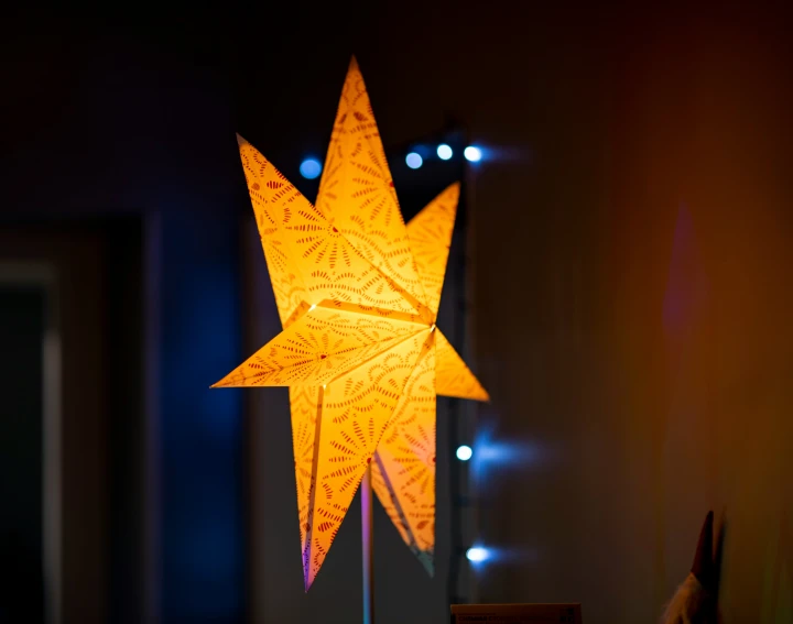 a star that is on a stick that is lit up in the dark